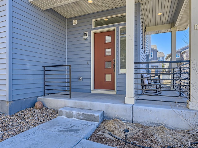 view of exterior entry featuring a porch