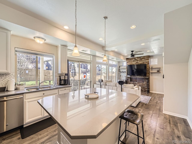 kitchen with dishwasher, backsplash, and a healthy amount of sunlight