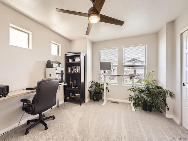 office with baseboards, visible vents, ceiling fan, a textured ceiling, and carpet floors