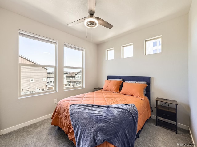 carpeted bedroom featuring a ceiling fan and baseboards