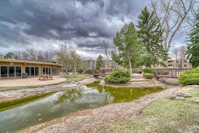 view of home's community with a patio area and fence