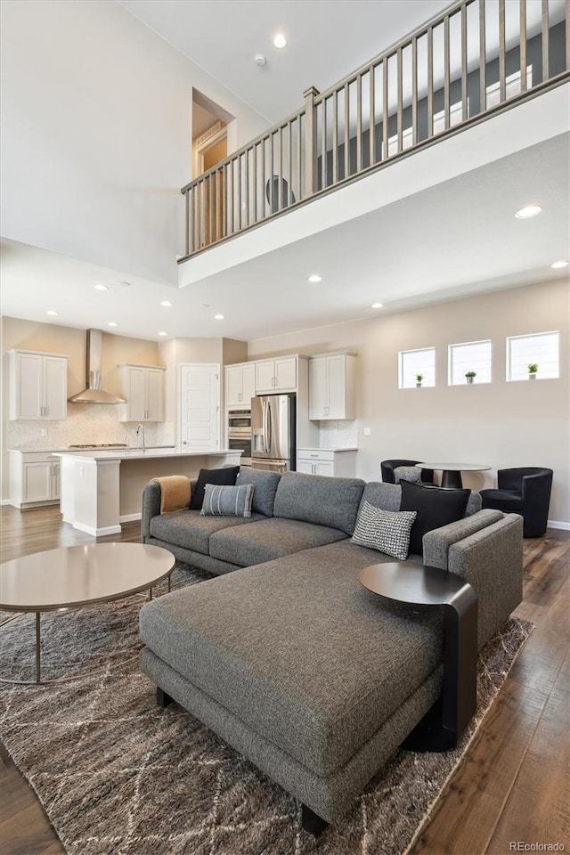 10557 Eby Cir, Lone Tree, CO 80124 - living room with a towering ceiling, dark wood-style flooring, and recessed lighting