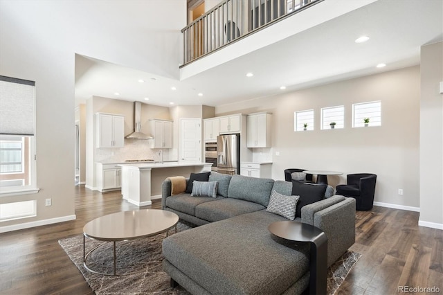 10557 Eby Cir, Lone Tree, CO 80124 - living room featuring a towering ceiling, dark wood-type flooring, and recessed lighting