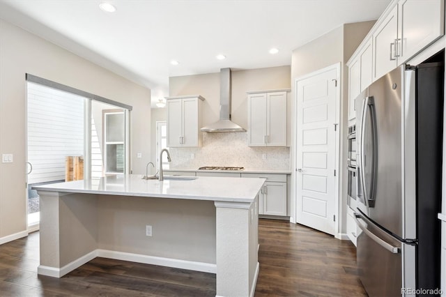 10557 Eby Cir, Lone Tree, CO 80124 - kitchen with freestanding refrigerator, wall chimney range hood, dark wood-type flooring, light countertops, and recessed lighting