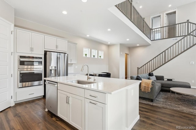 10557 Eby Cir, Lone Tree, CO 80124 - kitchen with appliances with stainless steel finishes, dark wood-style flooring, light countertops, recessed lighting, and white cabinetry