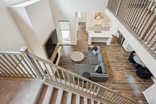 10557 Eby Cir, Lone Tree, CO 80124 - staircase featuring wood finished floors and a towering ceiling