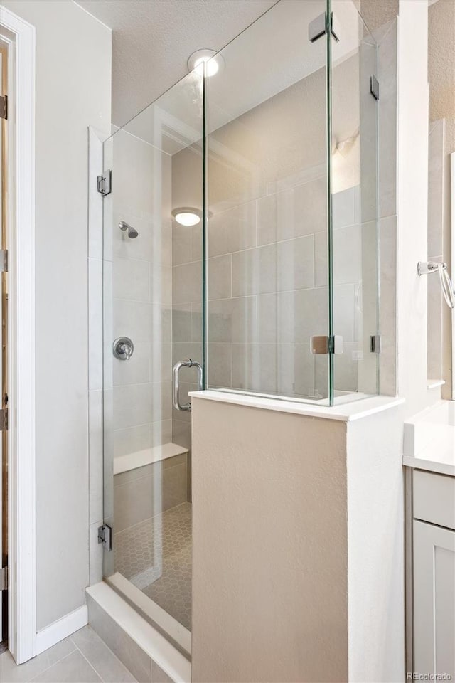 10557 Eby Cir, Lone Tree, CO 80124 - full bath featuring vanity, a shower stall, and tile patterned floors