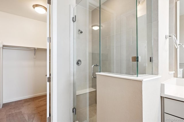 10557 Eby Cir, Lone Tree, CO 80124 - bathroom with a shower stall, a walk in closet, and vanity