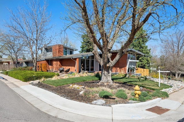 3895 Chimayo Rd, Littleton, CO 80123 - view of front of house featuring fence and brick siding
