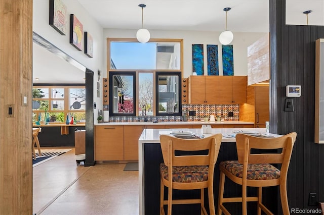 3895 Chimayo Rd, Littleton, CO 80123 - bar with tasteful backsplash, hanging light fixtures, and a sink