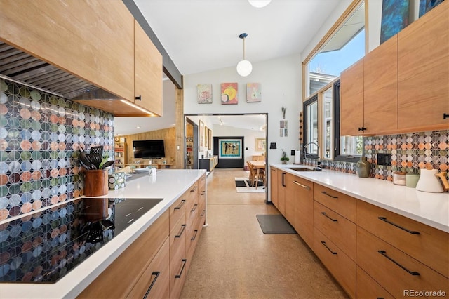 3895 Chimayo Rd, Littleton, CO 80123 - kitchen featuring black electric cooktop, a sink, light countertops, decorative backsplash, and lofted ceiling