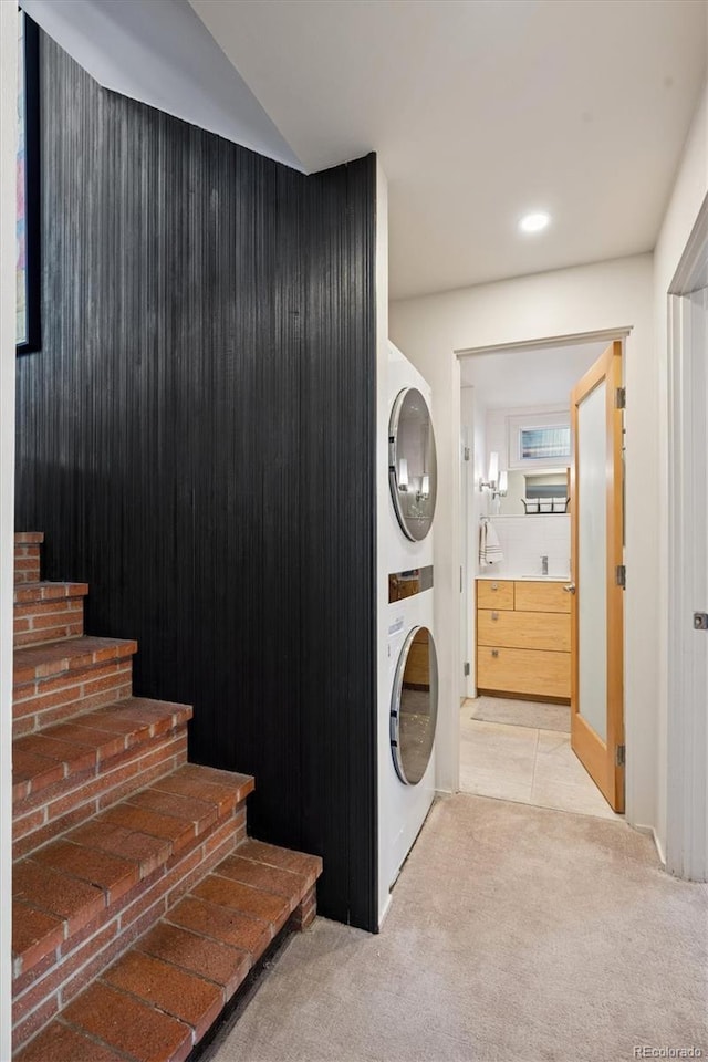 3895 Chimayo Rd, Littleton, CO 80123 - washroom with light carpet, recessed lighting, stacked washer and dryer, and laundry area