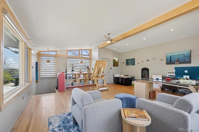 3895 Chimayo Rd, Littleton, CO 80123 - living room with baseboards, vaulted ceiling, a wood stove, ceiling fan, and wood finished floors