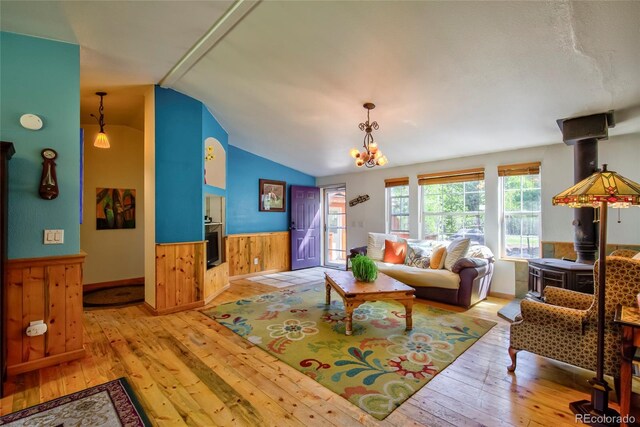 166 Ski Doo Rd, Fairplay, CO 80440 - living area with vaulted ceiling, hardwood / wood-style flooring, a wainscoted wall, a chandelier, and wooden walls