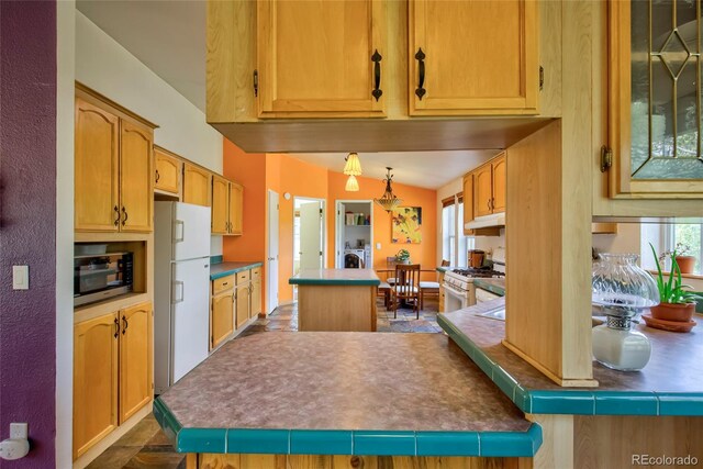 166 Ski Doo Rd, Fairplay, CO 80440 - kitchen featuring white appliances, a kitchen island, under cabinet range hood, and pendant lighting
