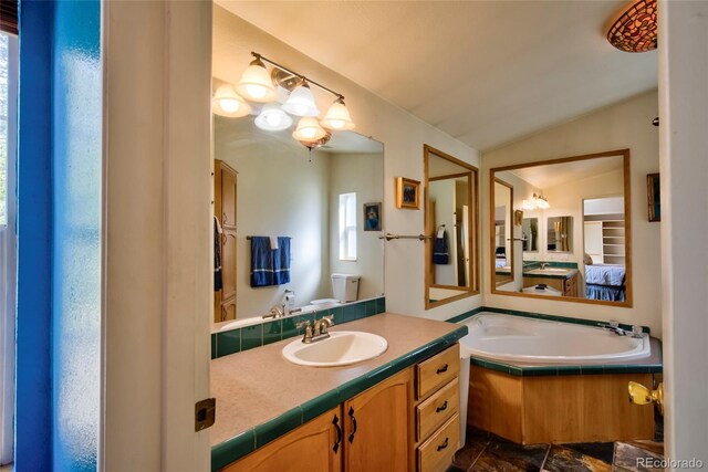 166 Ski Doo Rd, Fairplay, CO 80440 - bathroom featuring vaulted ceiling, vanity, toilet, ensuite bathroom, and a tub