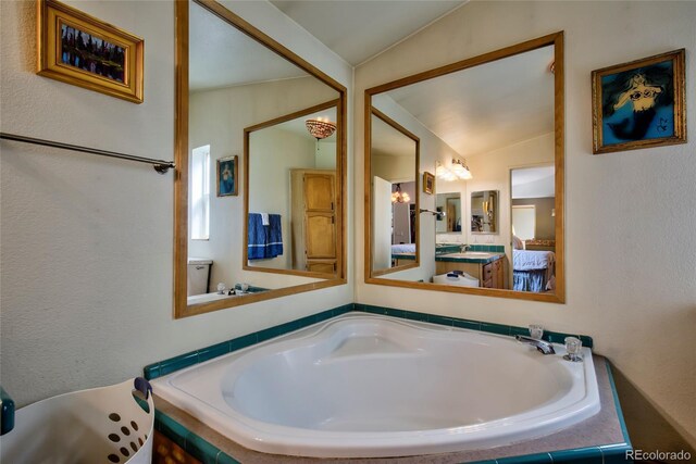 166 Ski Doo Rd, Fairplay, CO 80440 - full bathroom featuring vaulted ceiling, a bath, and vanity