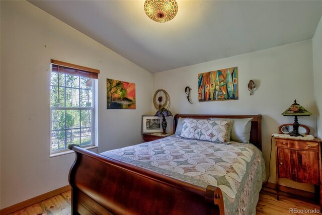 166 Ski Doo Rd, Fairplay, CO 80440 - bedroom featuring vaulted ceiling, light wood-style flooring, and baseboards