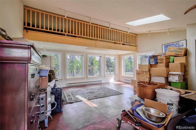 166 Ski Doo Rd, Fairplay, CO 80440 - interior space featuring track lighting, a baseboard heating unit, a skylight, and finished concrete flooring