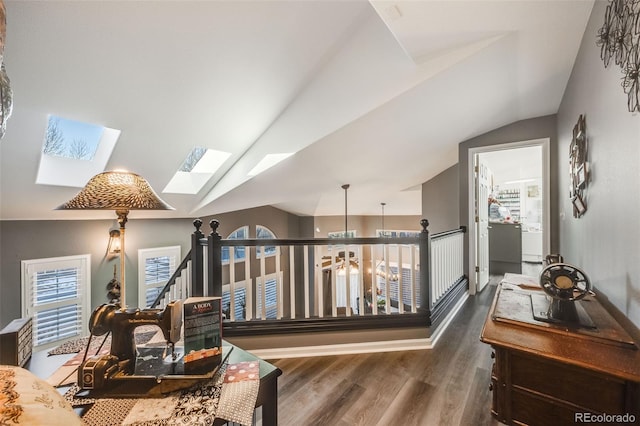 corridor featuring dark wood-type flooring and lofted ceiling with skylight