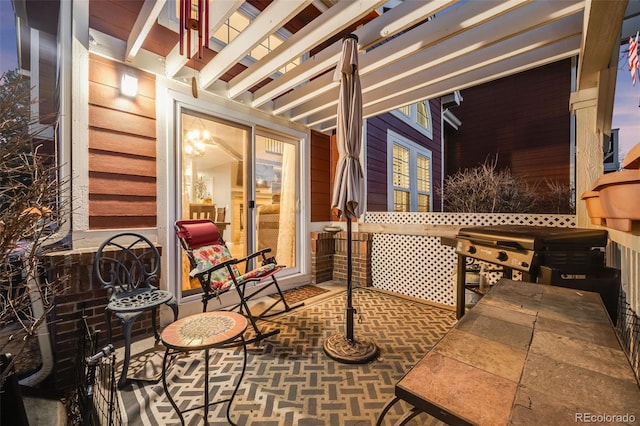 patio terrace at dusk featuring a hot tub and a pergola