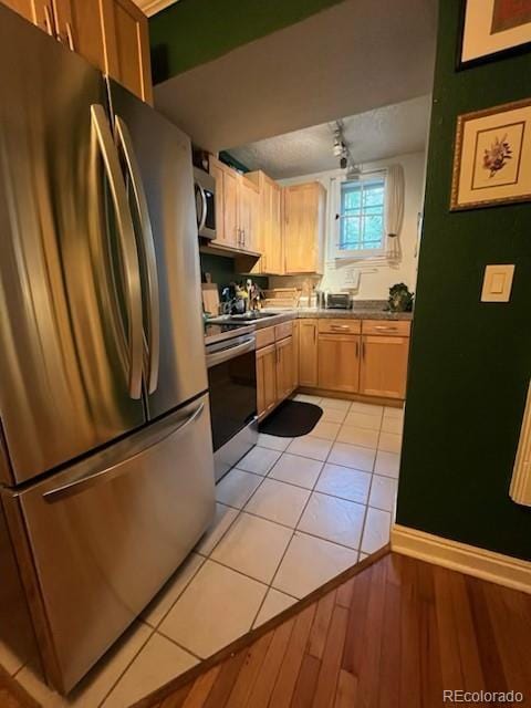 1024 E 14th Ave Unit 2, Denver, CO 80218 - kitchen featuring appliances with stainless steel finishes, track lighting, light wood-type flooring, light brown cabinets, and a sink