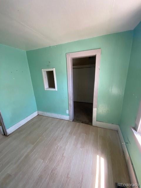 unfurnished bedroom featuring baseboards and wood finished floors