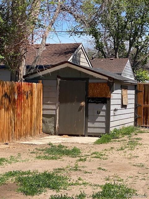 view of outbuilding with fence and an outbuilding