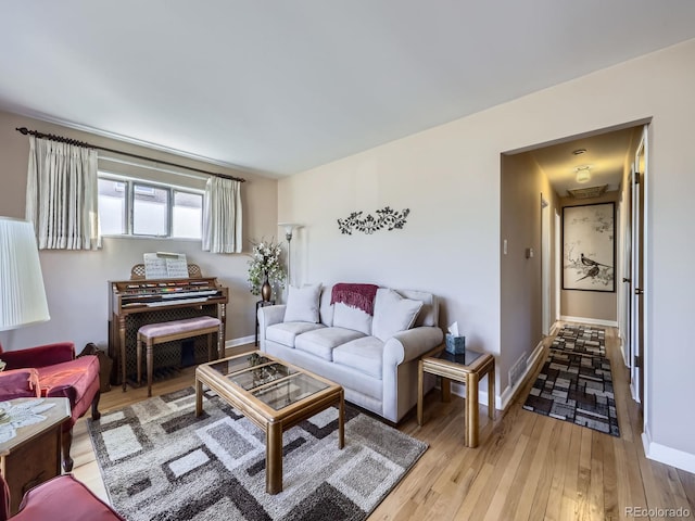 living room featuring light wood-style floors and baseboards