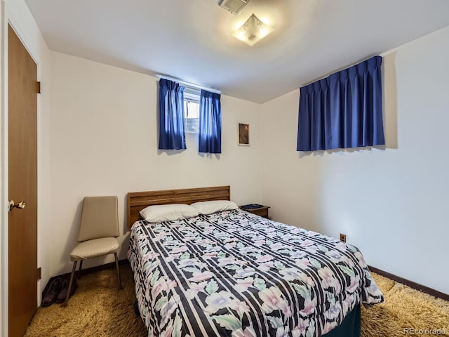 bedroom with carpet flooring, visible vents, and baseboards