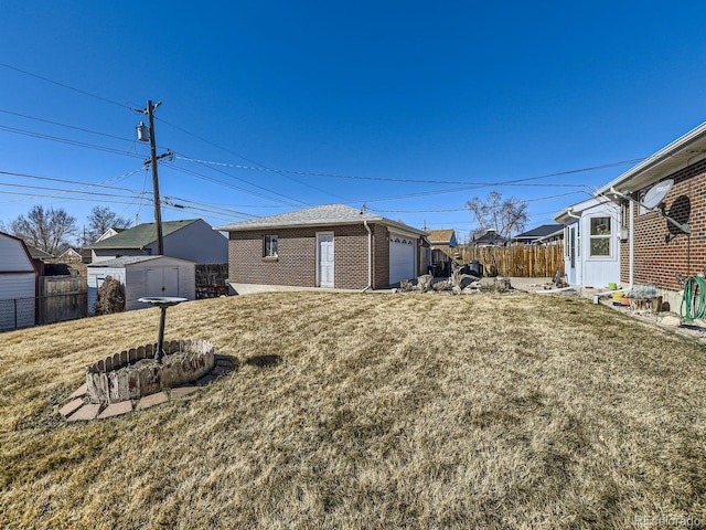 view of yard featuring an outdoor structure and fence