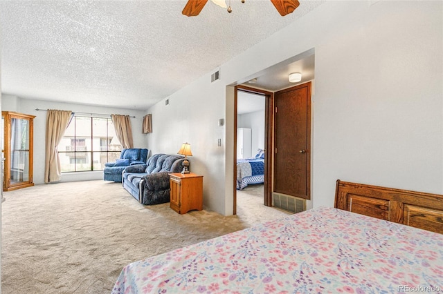 3550 S Harlan St Unit 214, Denver, CO 80235 - bedroom with carpet, a textured ceiling, and a ceiling fan