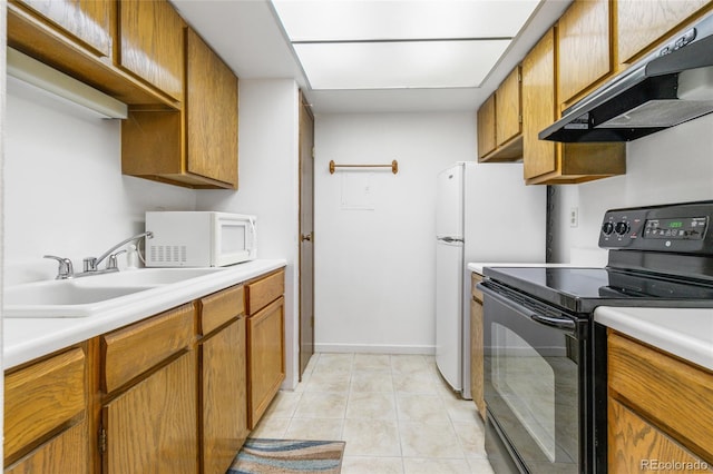 3550 S Harlan St Unit 214, Denver, CO 80235 - kitchen with black range with electric cooktop, white microwave, extractor fan, and light countertops