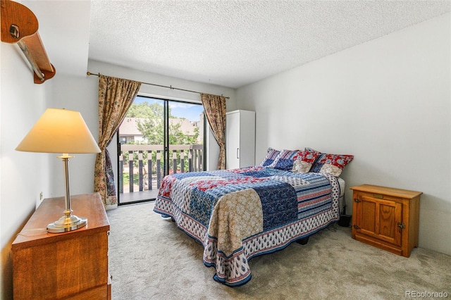 3550 S Harlan St Unit 214, Denver, CO 80235 - bedroom featuring carpet flooring, access to exterior, and a textured ceiling