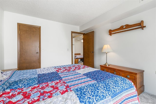 3550 S Harlan St Unit 214, Denver, CO 80235 - bedroom featuring a textured ceiling and light colored carpet