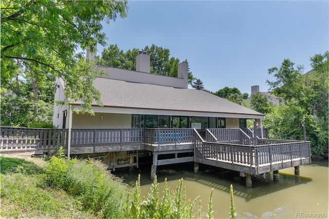 3550 S Harlan St Unit 214, Denver, CO 80235 - back of house with a deck with water view and a chimney
