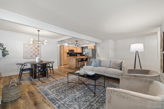 6290 Quail St, Arvada, CO 80004 - living room featuring a chandelier and light wood-style flooring