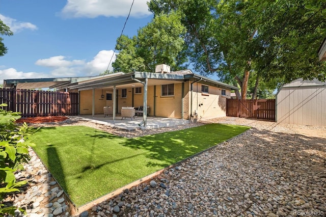 6290 Quail St, Arvada, CO 80004 - rear view of house with a fenced backyard, a patio area, brick siding, a storage shed, and a chimney