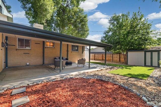 6290 Quail St, Arvada, CO 80004 - back of property with a patio area, a storage unit, brick siding, and an outdoor living space