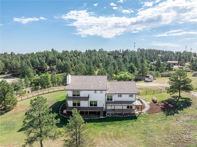 drone / aerial view featuring a wooded view