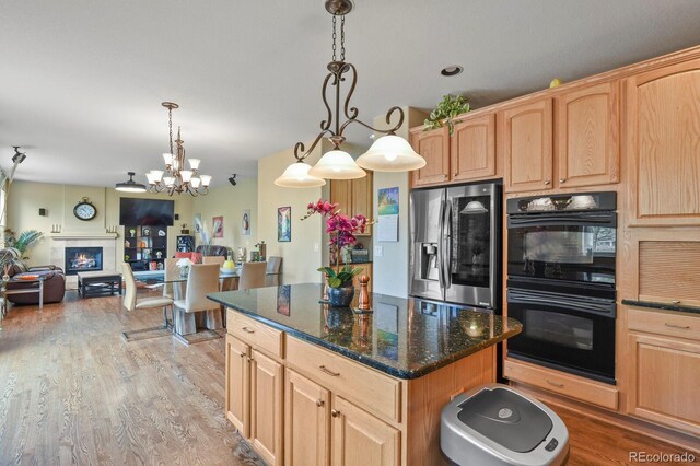 9536 W Avalon Dr, Littleton, CO 80127 - kitchen with stainless steel fridge, light brown cabinets, and a center island