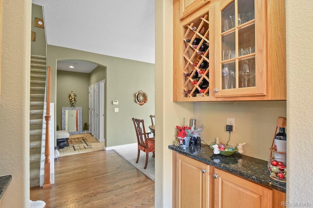 9536 W Avalon Dr, Littleton, CO 80127 - indoor dry bar featuring arched walkways and light wood-style flooring