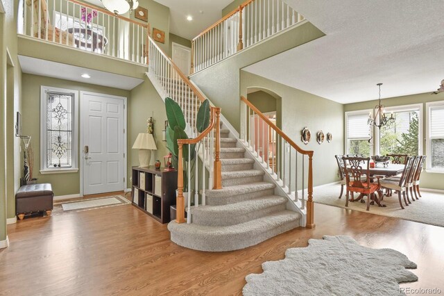 9536 W Avalon Dr, Littleton, CO 80127 - entrance foyer featuring stairs, wood finished floors, baseboards, and a high ceiling