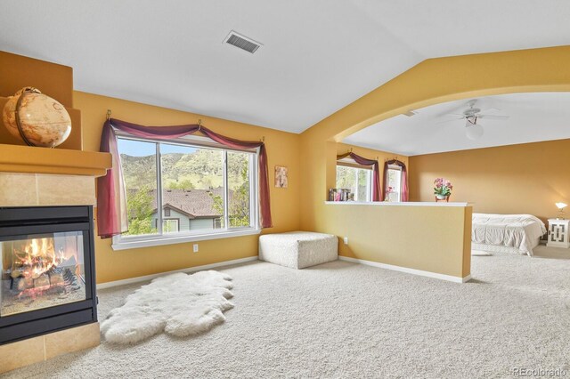 9536 W Avalon Dr, Littleton, CO 80127 - living area with carpet, vaulted ceiling, a ceiling fan, baseboards, and a fireplace