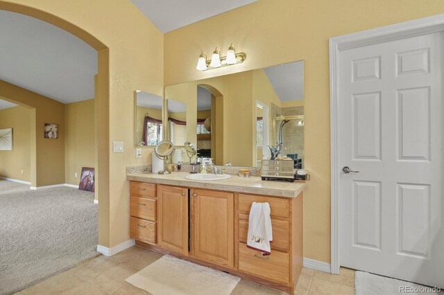 9536 W Avalon Dr, Littleton, CO 80127 - bathroom with a shower stall, vanity, baseboards, and tile patterned flooring