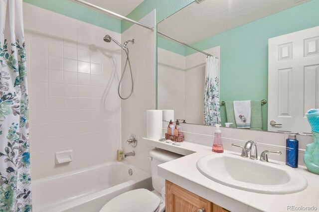 9536 W Avalon Dr, Littleton, CO 80127 - bathroom featuring shower / bath combo with shower curtain, toilet, and vanity