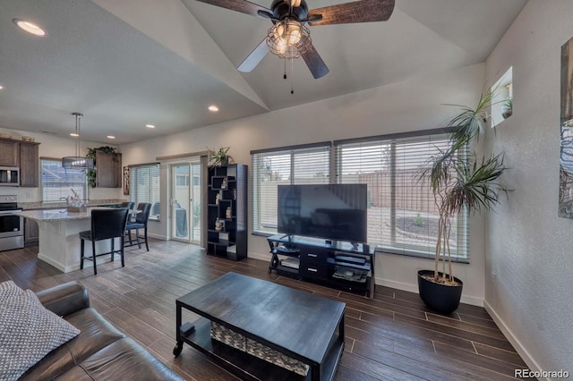 living room featuring vaulted ceiling, a textured wall, wood finish floors, and baseboards