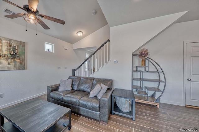 living area featuring lofted ceiling, stairs, visible vents, and wood finish floors