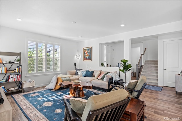 living area with stairway, baseboards, recessed lighting, and wood finished floors