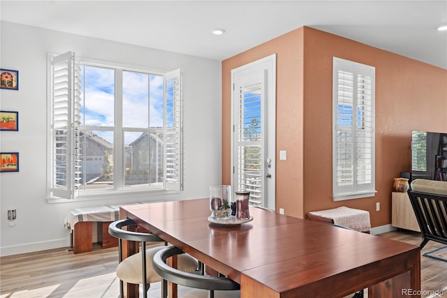 dining space featuring a healthy amount of sunlight, baseboards, recessed lighting, and light wood-style flooring